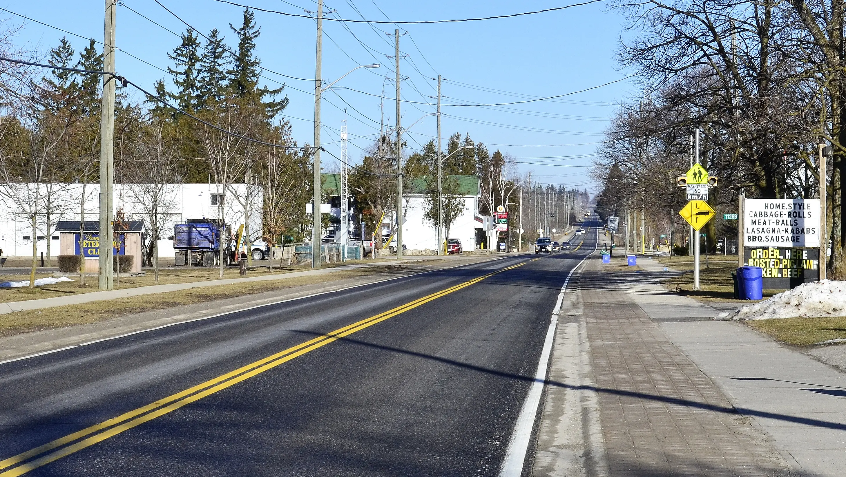 A Brookville, Ontario farm property with a country home, barn, and open fields along a concession road