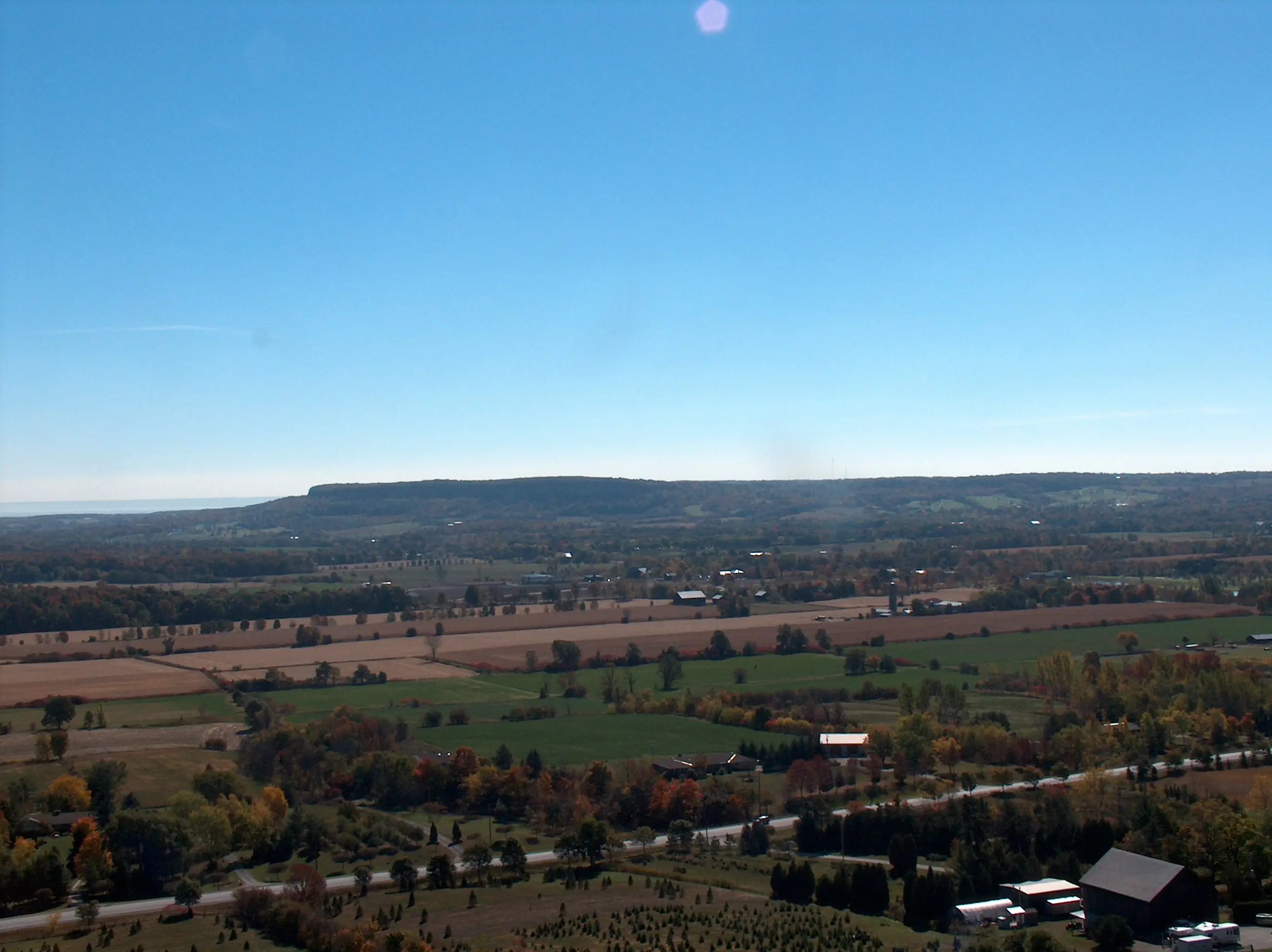 A rural Campbellville, Ontario estate property with acreage and outbuildings against a Niagara Escarpment backdrop